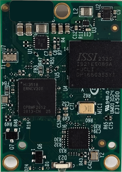 A close-up view of a green printed circuit board featuring multiple integrated circuits, resistors, capacitors, and other electronic components.